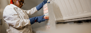 Technician removing samples from a freezer